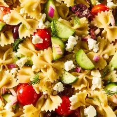 Ensalada de pasta con lazos, tomates cherry, pepino, queso feta, aceitunas y eneldo. ¡Una deliciosa pasta con verduras!