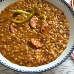 Un plato de lentejas con arroz, trozos de chorizo y guindillas verdes. Un clásico reconfortante.