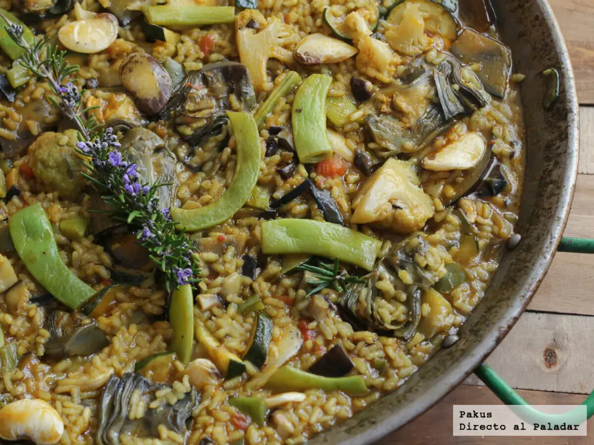 Arroz con verduras en paellera, con alcachofas, calabacín, pimientos y romero. Un plato lleno de sabor y color.